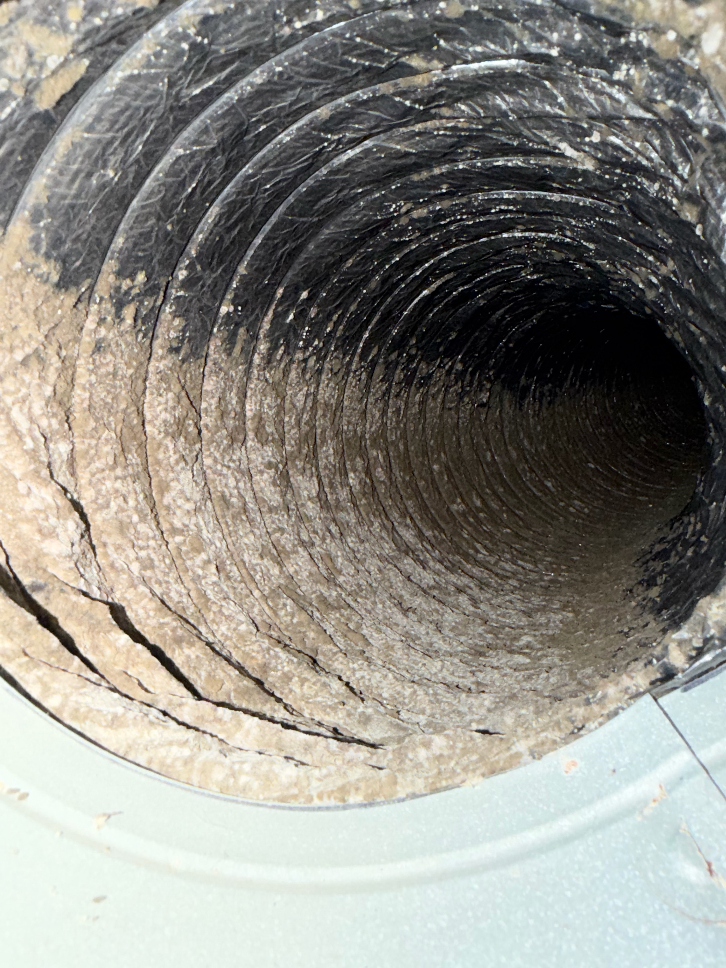 Dirty flexible air duct coated with dust