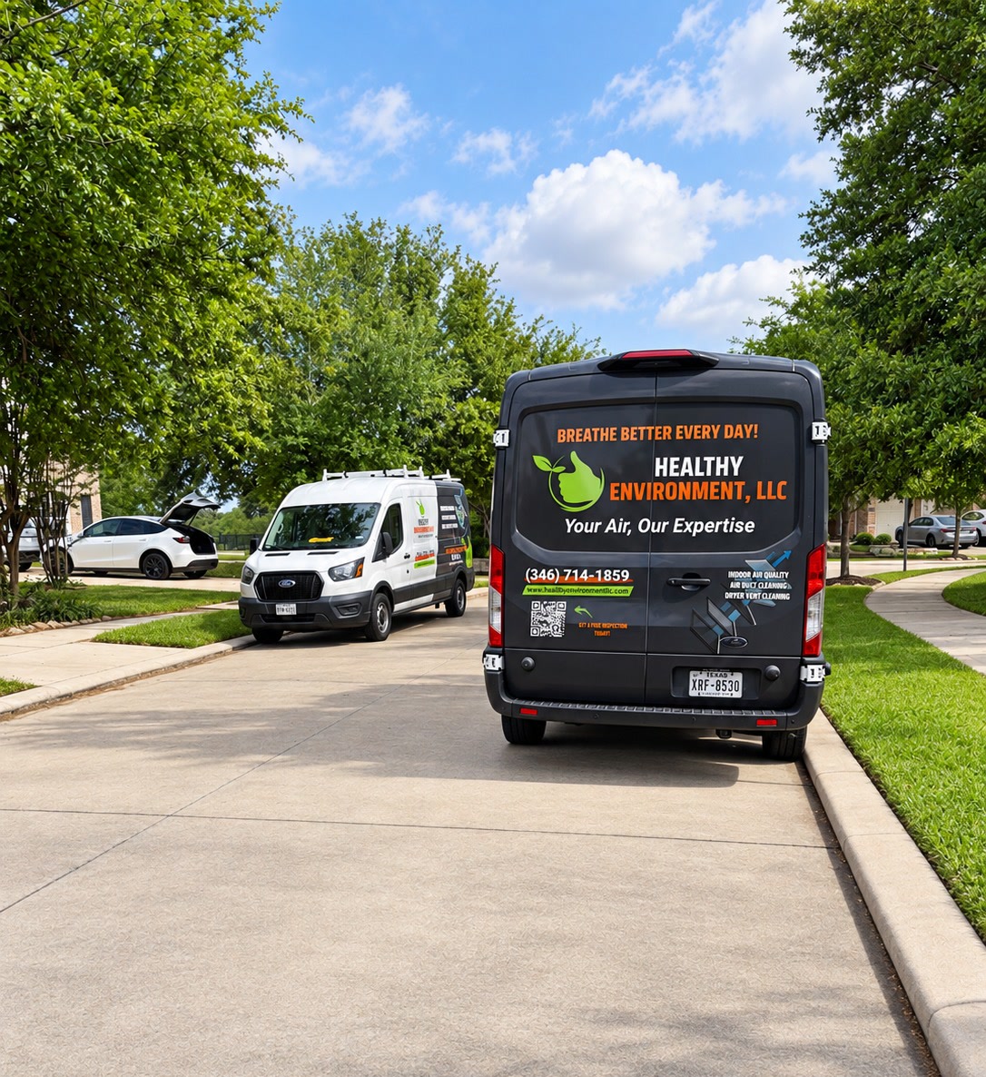 Healthy Environment air duct cleaning vans parked on a Sugar Land street
