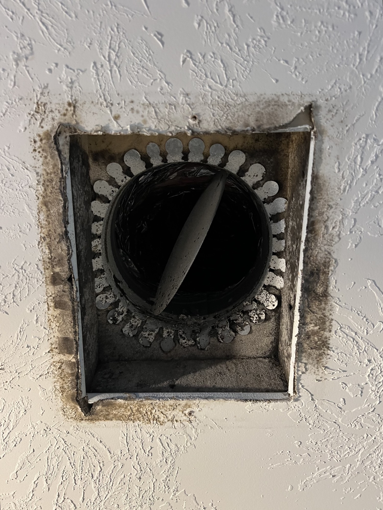 Dirty ceiling vent boot with dust and residue before air duct cleaning